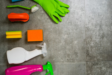 Cleaning products on stone background with copyspace