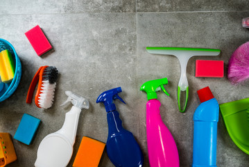 Cleaning products on stone background with copyspace