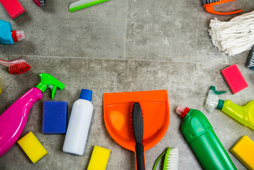 Cleaning products on stone background with copyspace