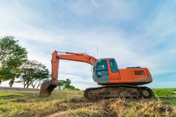 Close-up of a construction site excavator with blue sky