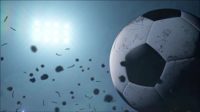 Soccer ball realistic rotation with stadium light behind in slow motion