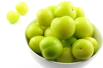 fresh turkish can erik plum fruits in a small white bowl