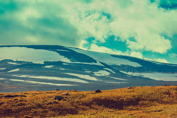 Obraz premium Mountain landscape in Lapland. Mountains covered with snow. Wilderness of Norway