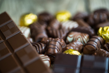 Variety of sweet homemade chocolate pralines and chocolate bars