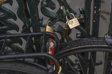 Love locks are on the modern bridge in Amsterdam (the Netherlands, Europe)