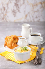 Breakfast - croissant, egg and coffee. Selective focus. Copy space