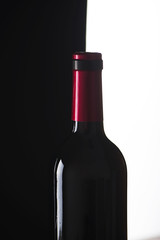 Bottle of wine on black and white background. Backlighting.