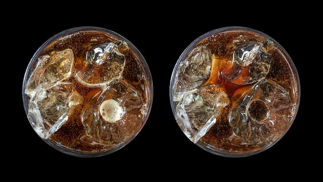 Refreshing bubbly soda pop, set of two top view cold cola glasses isolated on black background with clipping path.