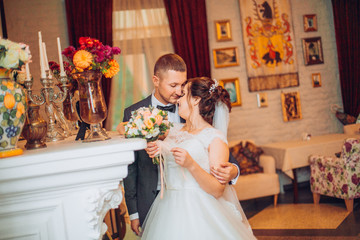 Happy bride and groom in interior of hotel in wedding day