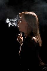 Fototapeta premium Beautiful girl vaping from e-cigarette.