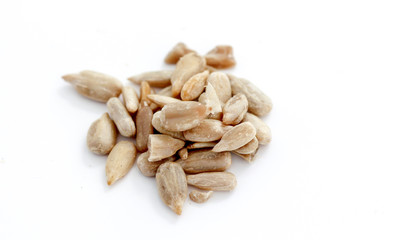 Natural shelled sunflower seeds on white background