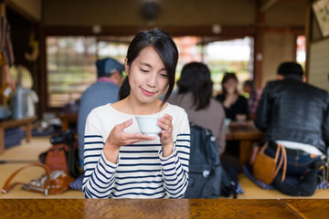 Woman enjoy her tea in japanese restaurant