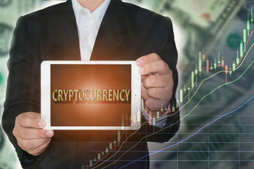 Cryptocurrency Concept : Business man showing tabet with cryptocurrency text and rising price graph on money background.