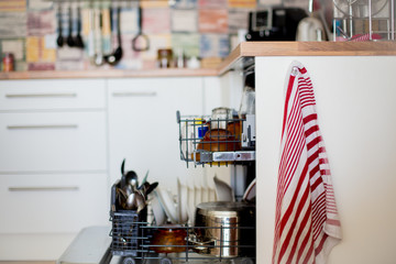 Dishwasher, filled with dirty dishes and glasses