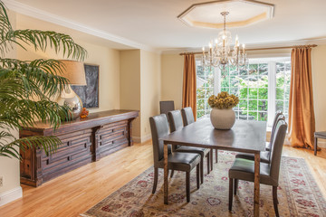 Elegant dining room with wood table and chandelier