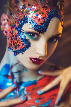 portrait of girl with fancy makeup in red and blue colors