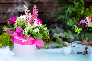 Beautiful decoration composition bouquet on a table and dry ice smoke
