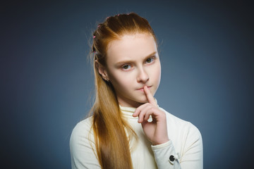 Closeup Thoughtful girl with Hand at head isolated on Gray