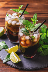 Cuba Libre cocktail with cola, lime, rum and peppermint