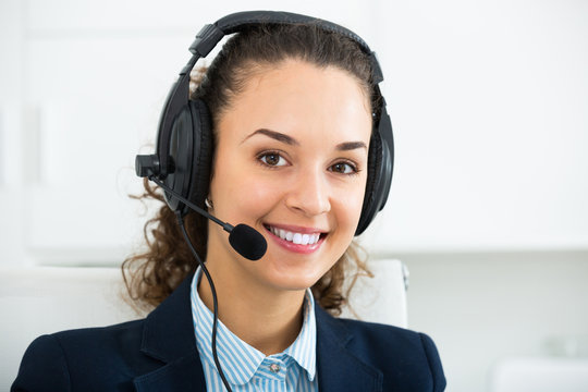 Woman professional call center operator talking with client