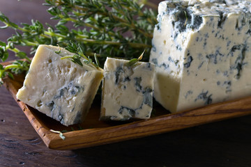 Blue cheese on a wooden table .