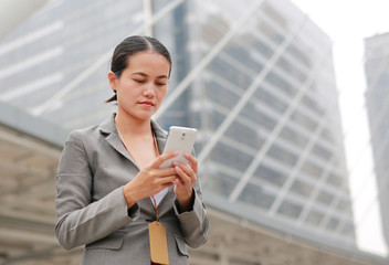 Beautiful business woman using telephone outdoors.