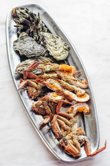 mixed fresh seafood selection gourmet set platter meal on table