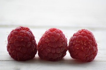 Beautiful fresh raspberry macro on white background 