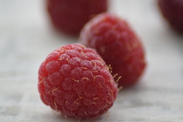 Beautiful fresh raspberry macro on white background 