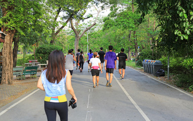 Group of people running in Park. rear view.