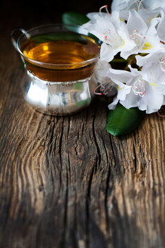 tea and White rhododendron on wood - wooden table