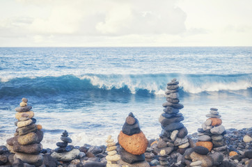 Concept of harmony and balance. Balance stones opposite the Atlantic ocean waves. Rock zen in the form of scales. Many balancing pebbles Stones Stacks. Canary islands, Tenerife, Adeje, Playa Del Duque
