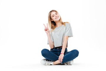 Young woman sitting cross-legged isolated