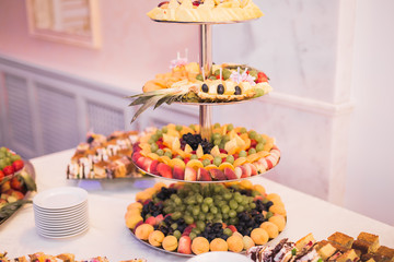 Delicious and tasty dessert table with cupcakes shots at reception closeup