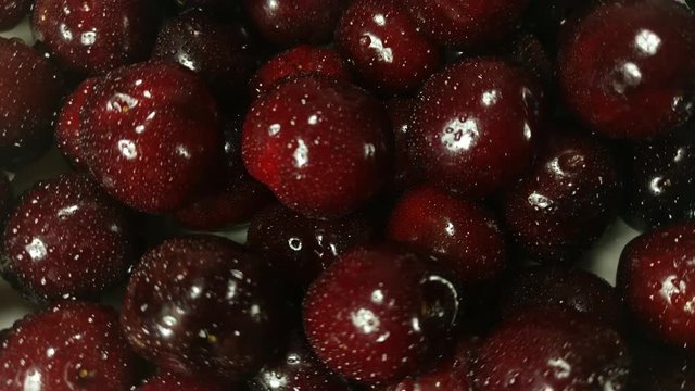 Great background of fresh cherry's berry rotating  close up.  Footage will work great for any videos dealing with summer, fun, relaxation, healthy nutrition and much more.