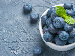 Blueberries in spoon on dark background
