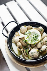stewed clams in garlic herb and white wine seafood sauce