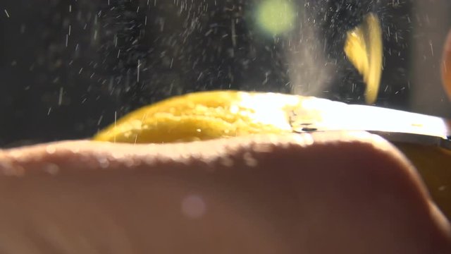 Slow motion peeling lemon skin. The particles of lemon peel are scattered in different directions. nutrition and wellness. Health food. Close-up. Macro