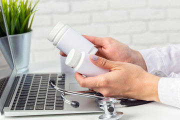 Female medicine doctor hands hold jar of pills
