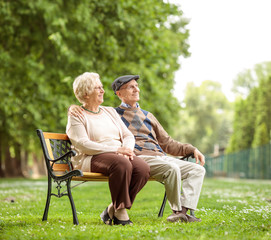 Senior couple sitting on a bench in the park