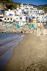 Beach with umbrellas at Sant Angelo on island Ischia, Italy