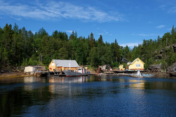 Naklejka premium Russia,Fjord At The White Sea Coast. Severe Northern Landscape With A Typical Fishing Village In The North Of Russia. Small Northern Village In The Abandoned Forest Area On The North Of Russia