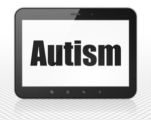 Medicine concept: Tablet Pc Computer with Autism on display