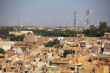 Jaisalmer, India. Streets with cell towers and wind power generators