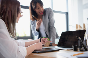 young multiethnic designers working at office with digital devices