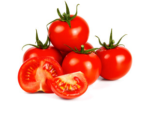 A few fresh tomatoes and one cut on a white background