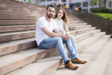 Young couple sitting in stairs at university campus