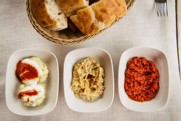 meze small dishes on the table: hummus, Antep Ezmesi