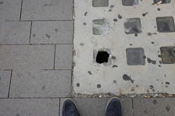Dangerous hole on the sidewalk