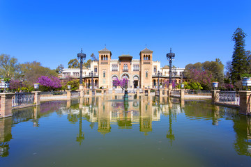 Fototapeta na wymiar The mudejar pavilion and pond placed in the Plaza de America, houses the Museum of Arts and Traditions of Sevilla, Andalusia,